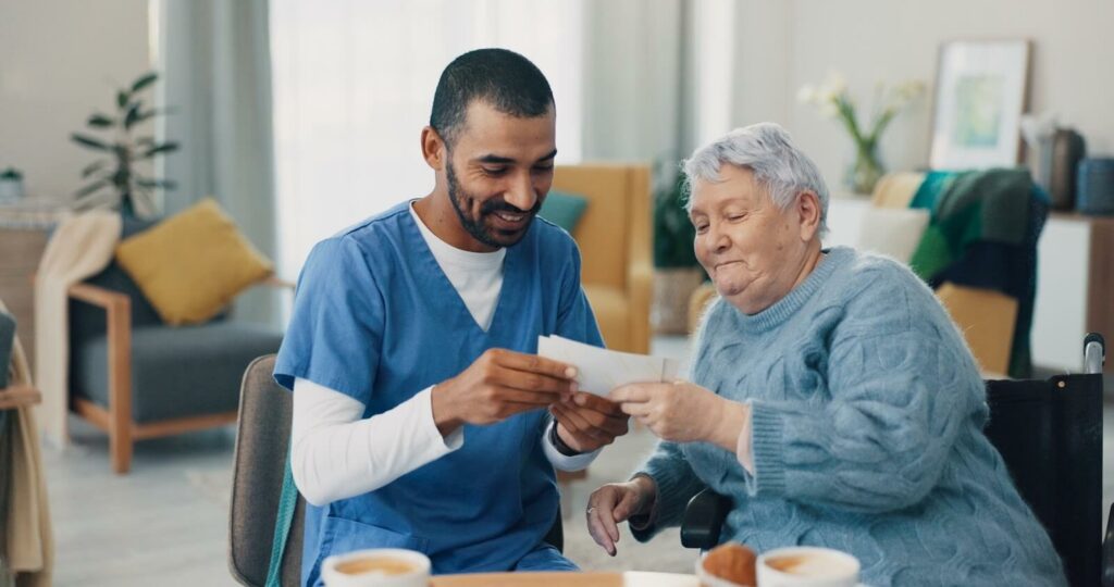 A memory care team member shares photos with a resident.